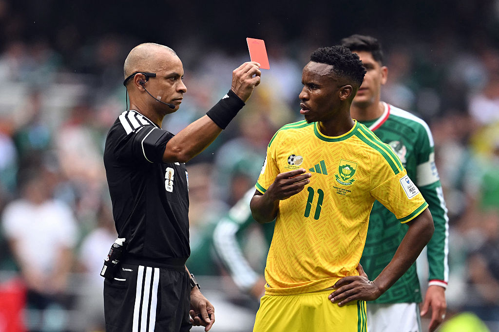 Brazilian referee Wilton Sampaio shows a red card to South Africa's midfielder #11 Themba Zwane during the 2026 World Cup Group A football match between Mexico and South Africa