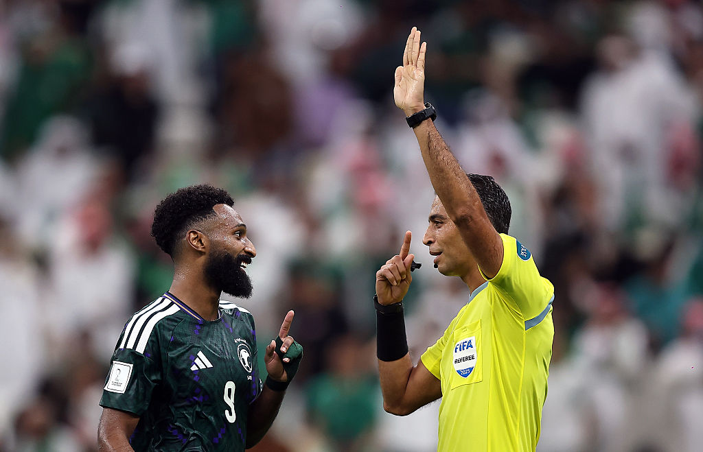 LUSAIL CITY, QATAR - DECEMBER 11: Referee Amin Mohamed Omar and Feras Albrikan of Saudi Arabia interact during the FIFA Arab Cup 2025 Quarter Final match between Palestine and Saudi Arabia at Lusail Stadium on December 11, 2025 in Lusail City, Qatar. (Photo by Mohamed Farag - FIFA/FIFA via Getty Images)