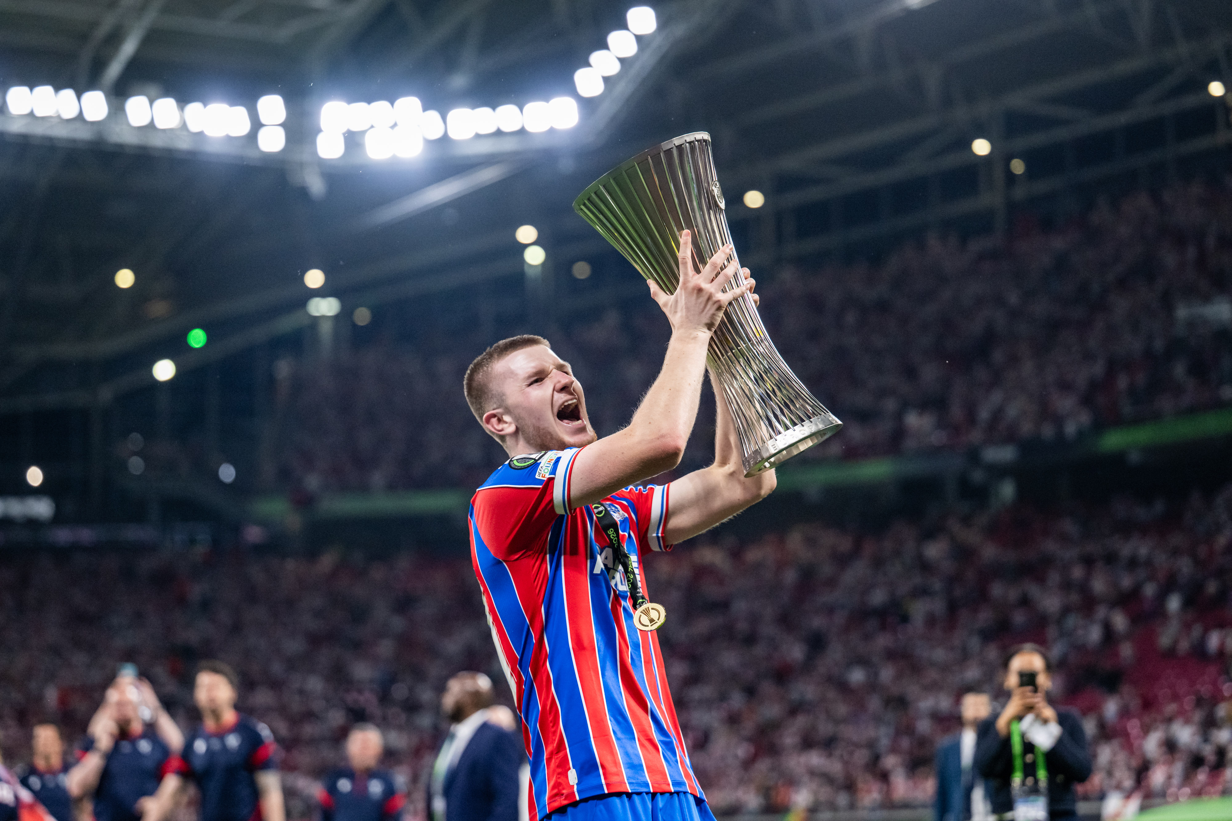 LEIPZIG, GERMANY - MAY 27: Adam Wharton of Crystal Palace celebrates with the UEFA Conference League Trophy following the UEFA Conference League Final 2026 match. (Photo by Kevin Voigt/GettyImages)