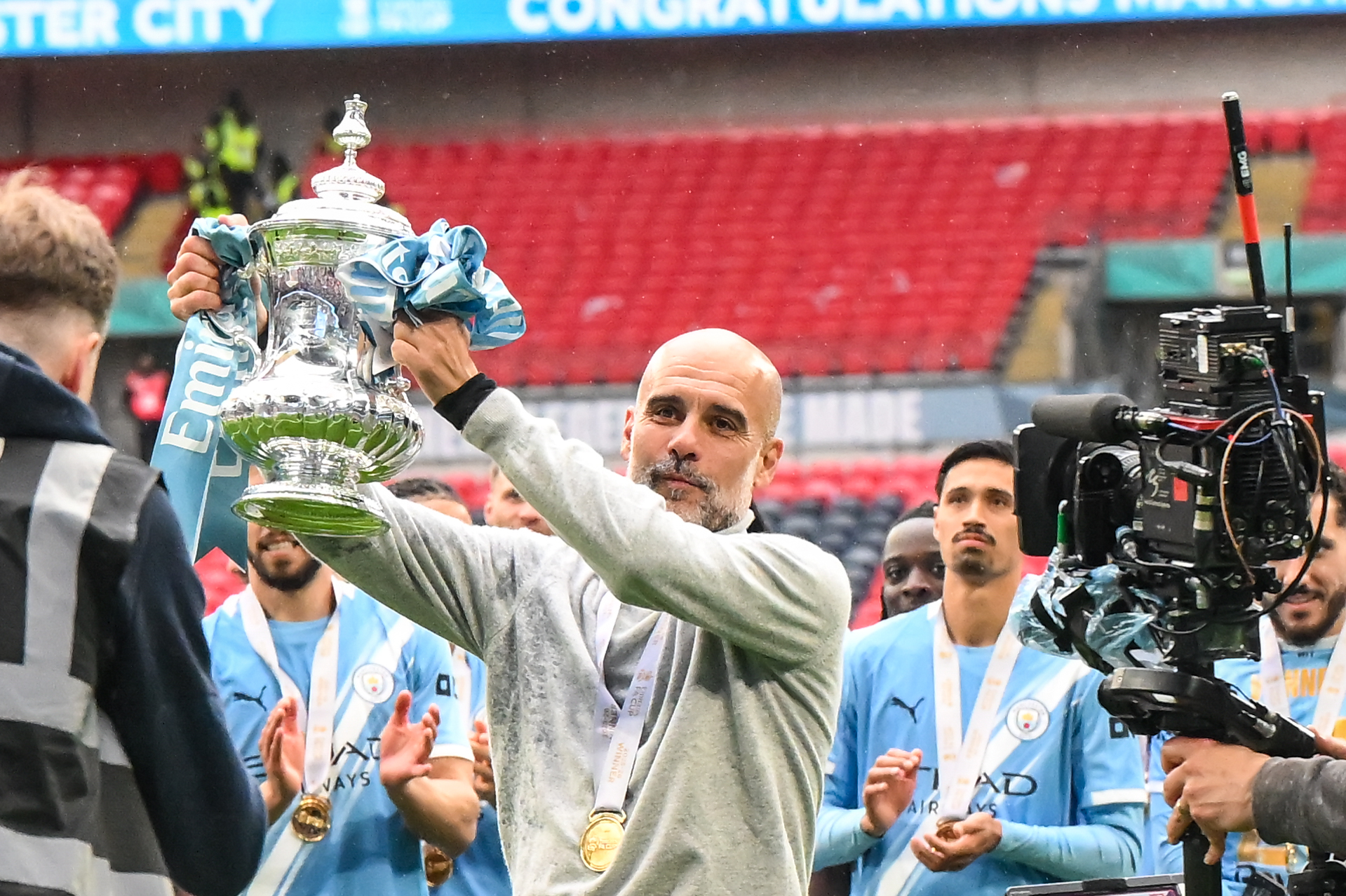 Pep Guardiola holds the Emirates FA Cup
