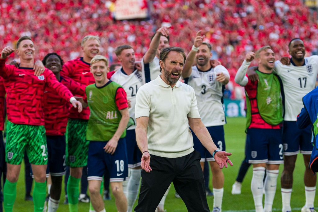 England players including Cole Palmer, Declan Rice and Luke Shaw celebrate together behind Gareth Southgate at Euro 2024