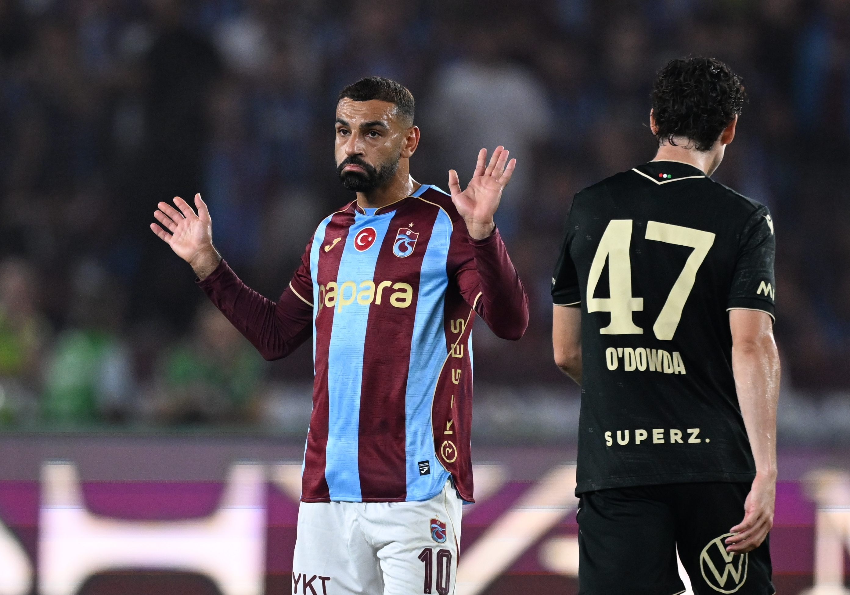 Mohamed Salah gestures, hands raised, in a Trabzonspor shirt. (Photo by Hakan Burak Altunoz/Anadolu via Getty Images)