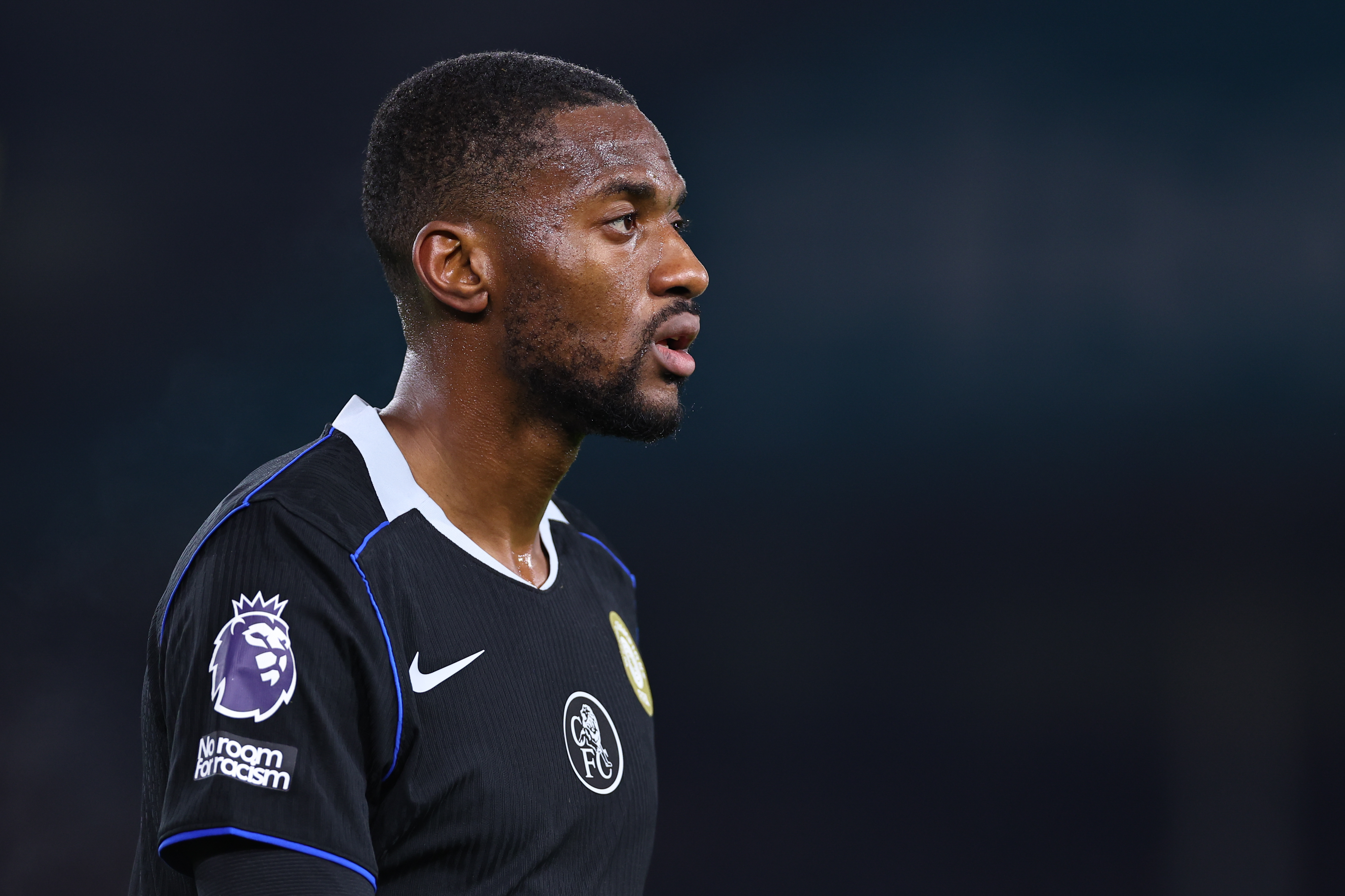 Tosin Adarabioyo of Chelsea walking, side profile, mid shot.